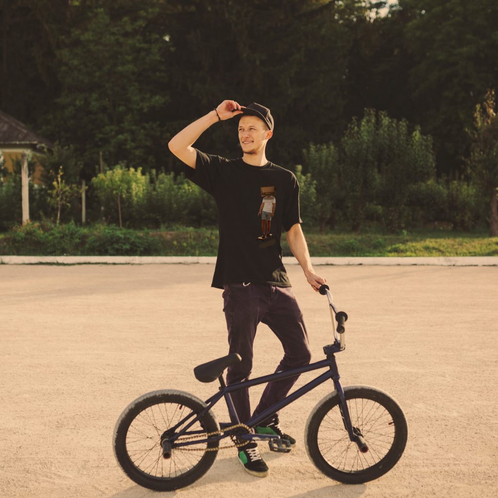 Young BMX bicycle rider having fun and posing